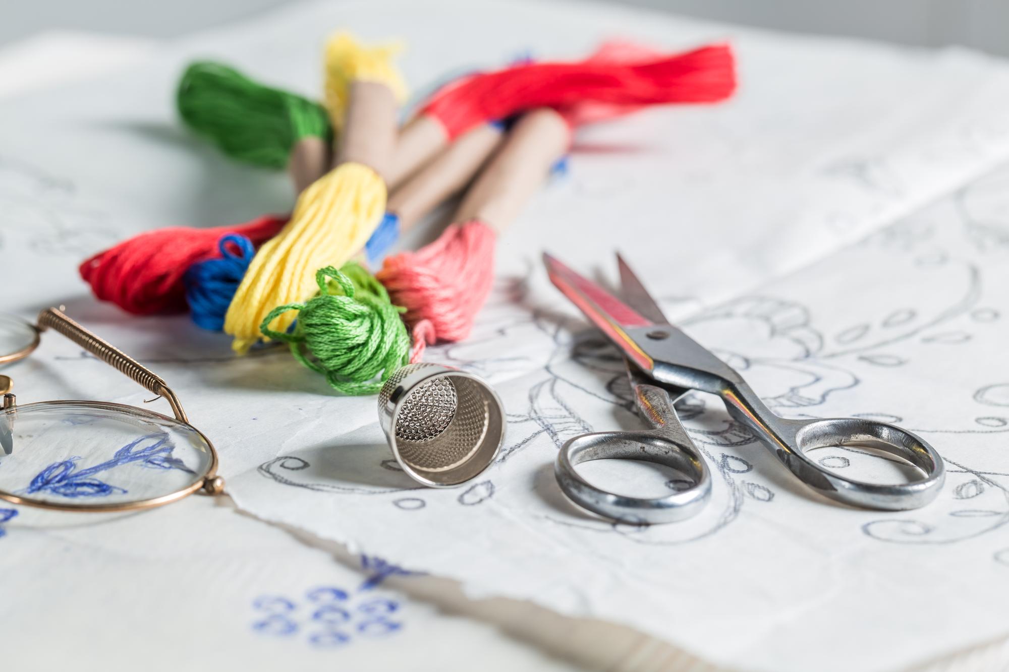 Workshop bench with sketches and threads